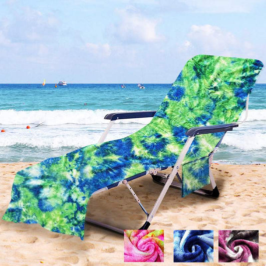 Green and blue tie-dye towel displayed over a reclining beach chair, with fabric extending along the backrest and leg section