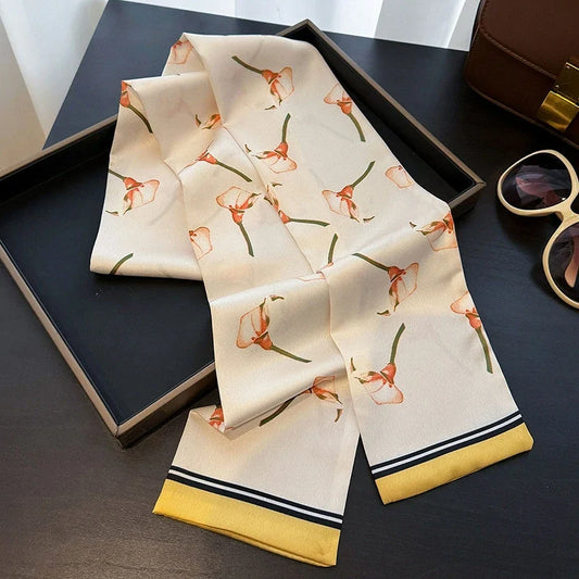 Long narrow botanical-print skinny scarf displayed for styling