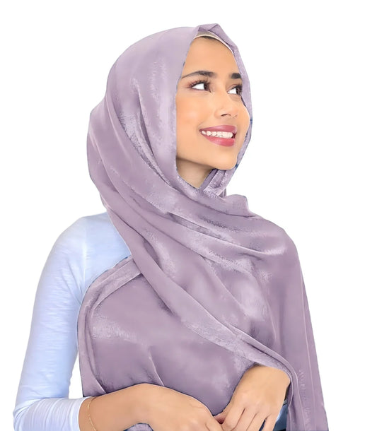 Lilac shimmer hijab draped around a model's head and shoulders