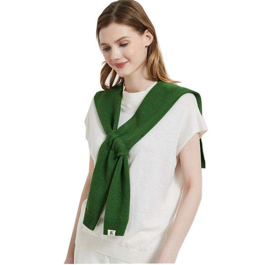 Green knitted shoulder shawl tied at the front over a model's white short-sleeved crew-neck top