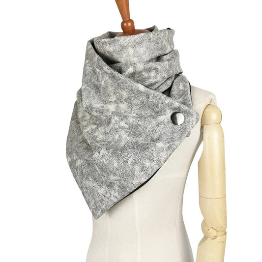 Grey snap neck warmer on a mannequin showing its raised collar and triangular front