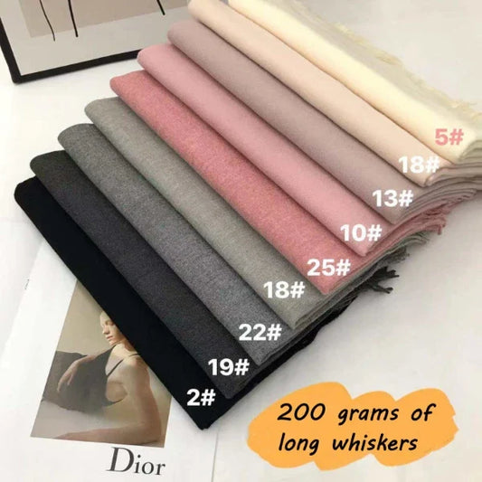 Folded plain fringed scarves in cream, pink, grey and black colour options