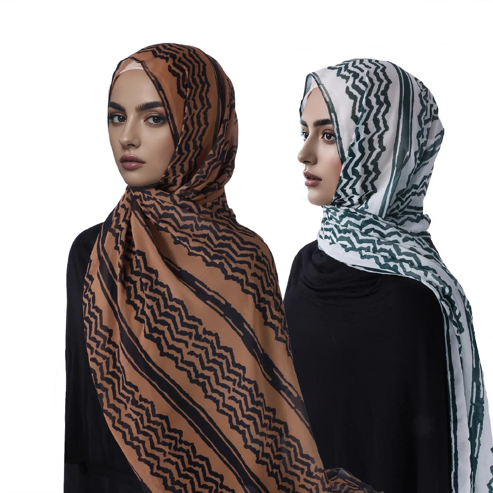 Two women wearing keffiyeh scarves.