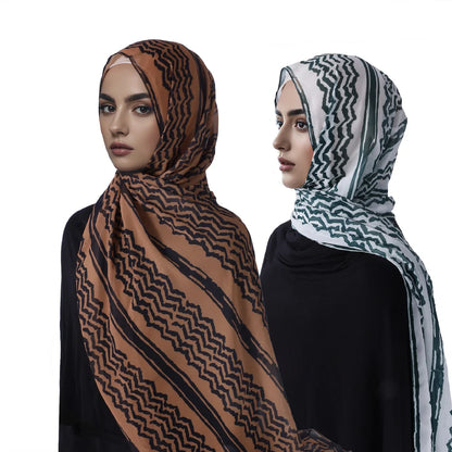 Two women wearing keffiyeh scarves.