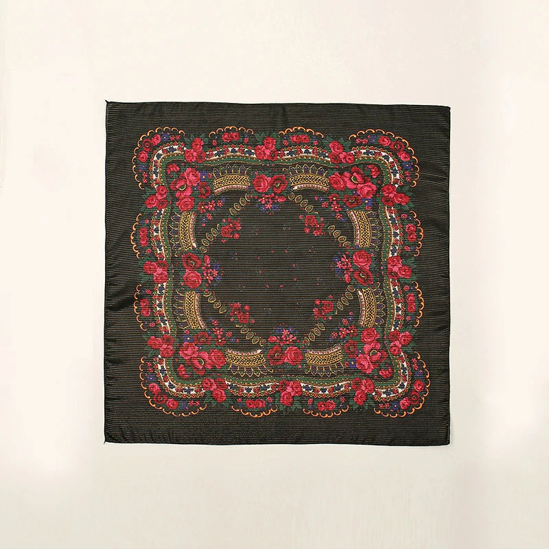 A red embroidered black headscarf unfolded