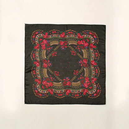 A red embroidered black headscarf unfolded
