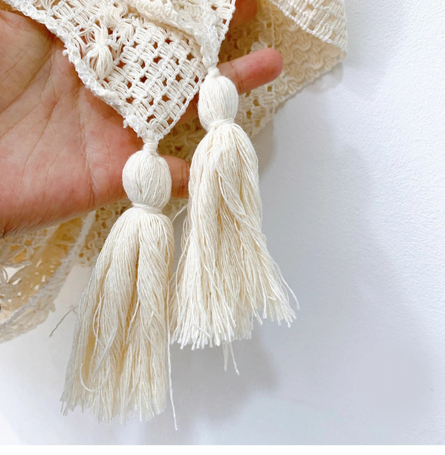 Beige knitted shawl with tassels