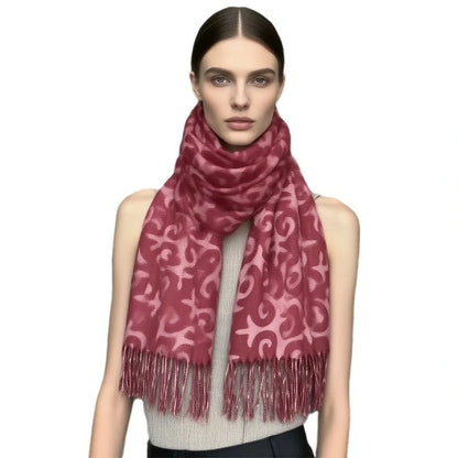 A woman wearing a red cross-stitch scarf