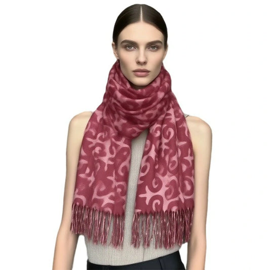 A woman wearing a red cross-stitch scarf